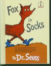 A red fox in blue socks is walking across the ground with the words Fox in Socks around it. Only the front half of the fox is visible. 