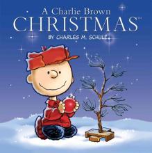Book cover shows Charlie Brown sitting in the snow next to a sad little evergreen tree.